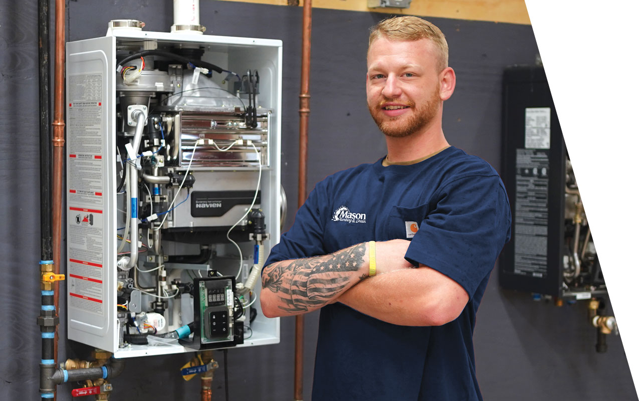 Plumber in front of a tankless water heater